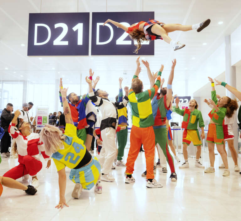 A vibrant choreographed performance brings festive energy to the airport.