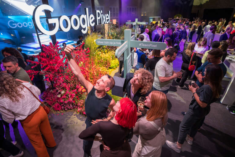 Participants taking a selfie in a branded space at a Google Pixel B2B event