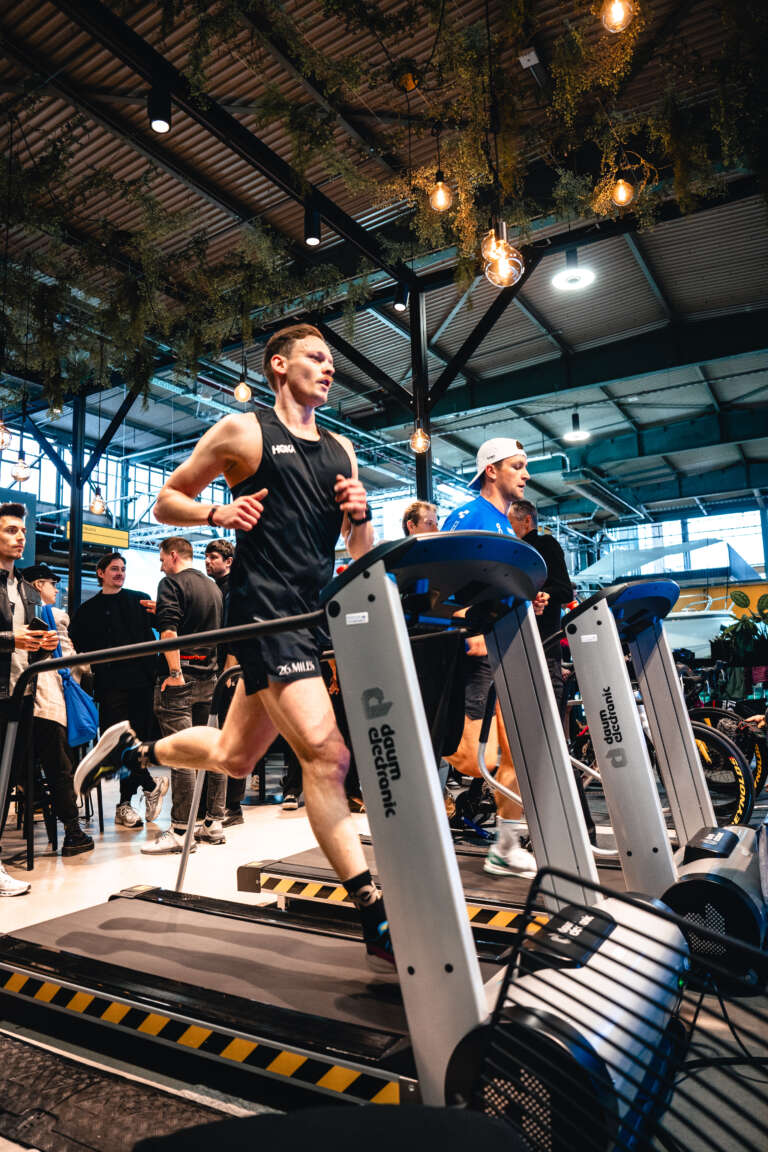Athletes running on treadmills during a branded sports event