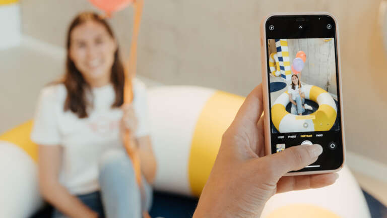 Child photographed with colorful balloons during a joyful family activation