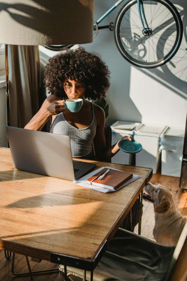 Employee working remotely from home, accompanied by her dog